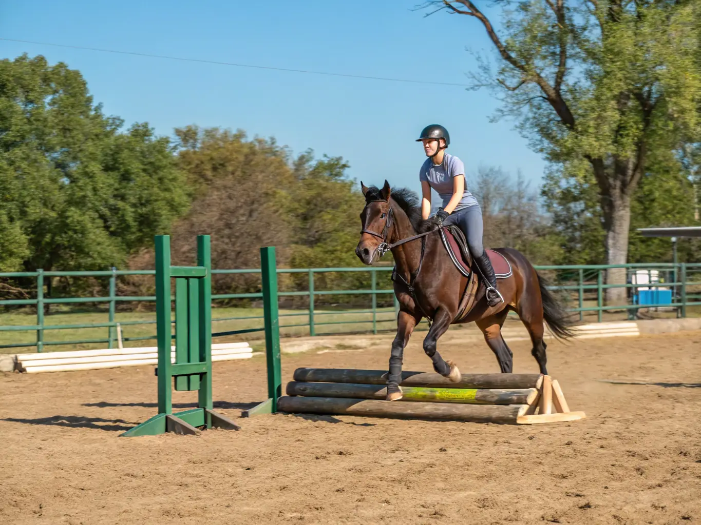 A young rider confidently navigating an obstacle course during a training session at RENCONTRES EQUESTRES DE CHAMBERET, demonstrating skill development and focus.