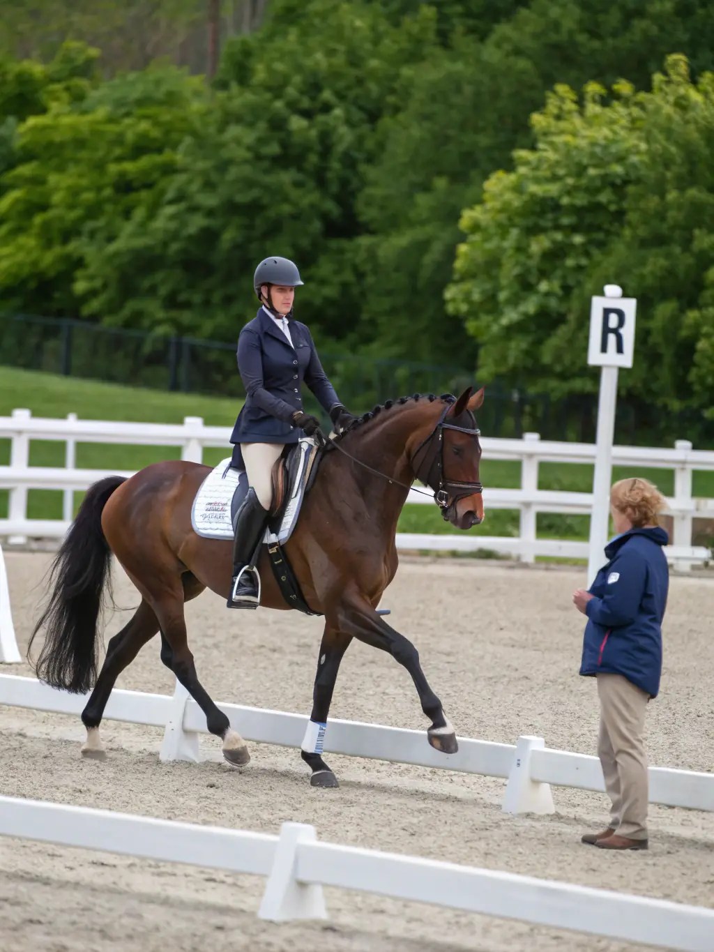 A therapeutic riding session at RENCONTRES EQUESTRES DE CHAMBERET, showing a disabled individual benefiting from the physical and emotional support of the horse.