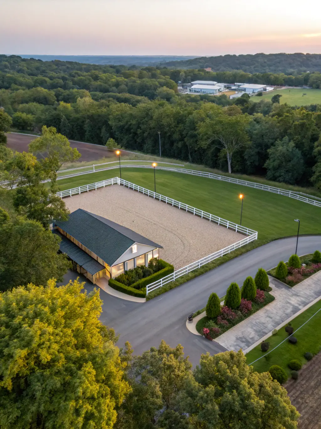 A well-maintained outdoor riding arena at RENCONTRES EQUESTRES DE CHAMBERET, featuring a sand surface, surrounded by green fields and trees, with horses and riders in action during a training session.